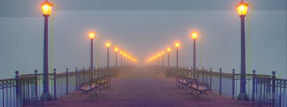 Foggy illuminated pier